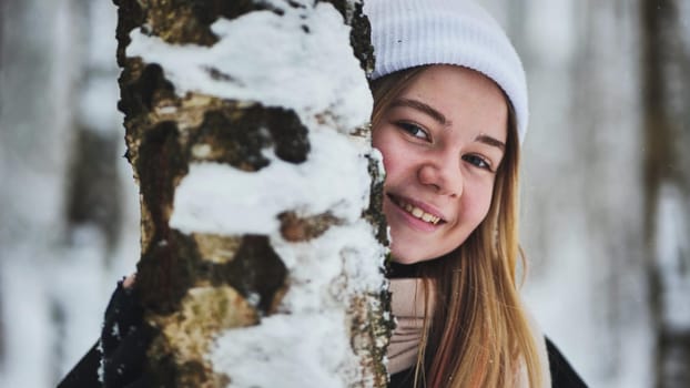 Portrait of a girl in winter in a birch forest