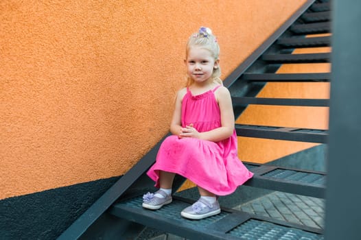 Child with hearing problem and cochlear implant dance in street, deaf kid began to hear. Hearing loss in childhood and treatment concept. Copy space and empty place for text.