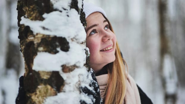 Portrait of a girl in winter in a birch forest