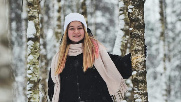 Portrait of a girl in winter in a birch forest