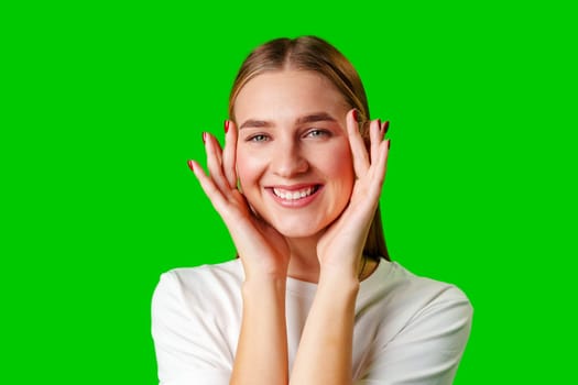 Young Woman Poses for Picture against green background in studio