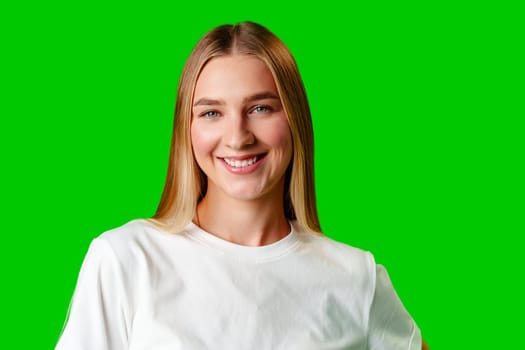 Young Woman in White Shirt Posing for Picture against green background in studio