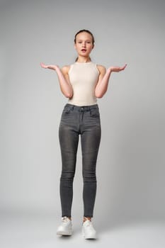 Startled Woman With Surprised Expression on gray background in studio