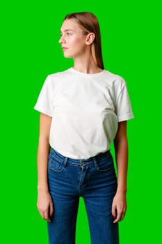 Young Woman in White Shirt Posing for Picture against green background in studio