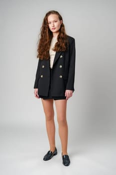 Young Woman in Short Skirt and Jacket Posing for Picture in studio