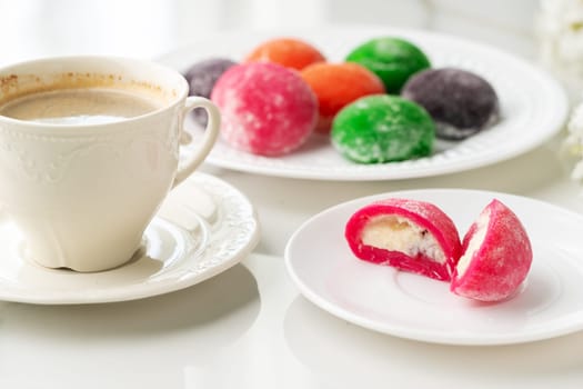 Multi-colored Japanese cakes Mochi in a white plate close up