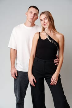 A Man and a Woman Standing Next to Each Other in studio posing