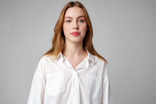 Young Woman Wearing Gray Suit and White Shirt on gray background