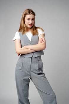 Young Woman Wearing Gray Suit and White Shirt on gray background