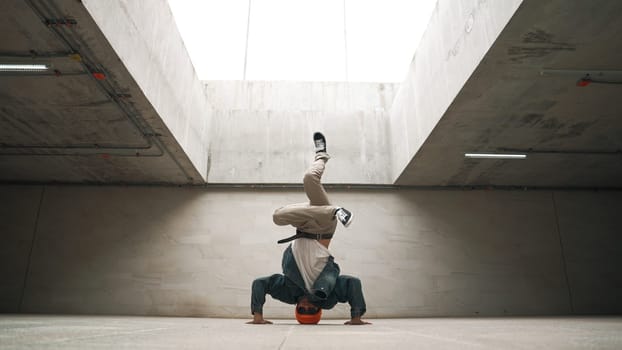 Stylish happy hipster perform break dance or freestyle foot step in building. Professional break dancer practice b-boy dance while wear stylish cloth. Modern lifestyle. Outdoor sport 2024. Sprightly.