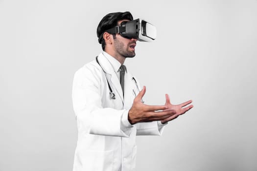 Caucasian smart doctor wearing VR goggles and lab coat while explaining medical theory. Professional doctor analysis medical data while connect metaverse by using visual reality headsets. Deviation.