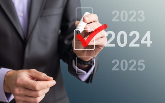 man hand touching on 2024 calender year button on digital virtual screen blur background. High quality photo