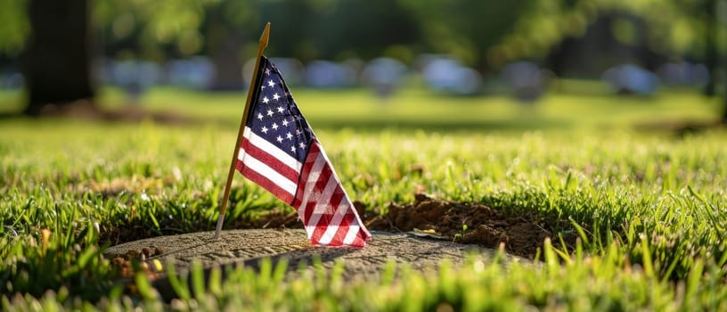 A solitary American flag on a weathered wooden cross at a veterans cemetery, conveying a message of memory and respect