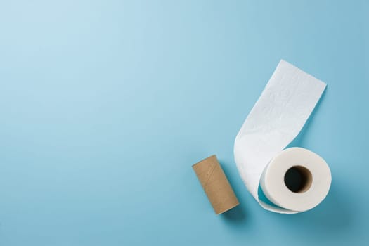 Top view of toilet paper roll on blue background