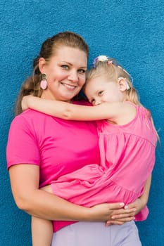 Child girl with cochlear implant with her mother spend time outdoor. Hear impairment and deaf community concept. Deaf and health concept. Diversity and inclusion. Copy space.