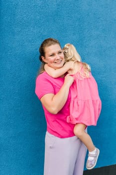 Child girl with cochlear implant with her mother spend time outdoor. Hear impairment and deaf community concept. Deaf and health concept. Diversity and inclusion. Copy space.