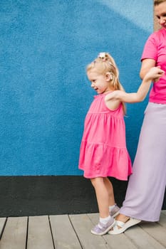 Child with hearing problem and cochlear implant dance in street, deaf kid began to hear. Hearing loss in childhood and treatment concept. Copy space and empty place for text.