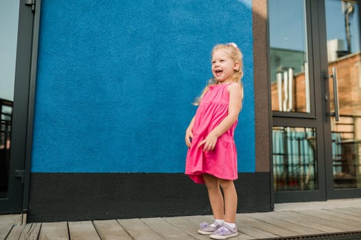 Child with hearing problem and cochlear implant dance in street, deaf kid began to hear. Hearing loss in childhood and treatment concept. Copy space and empty place for text.