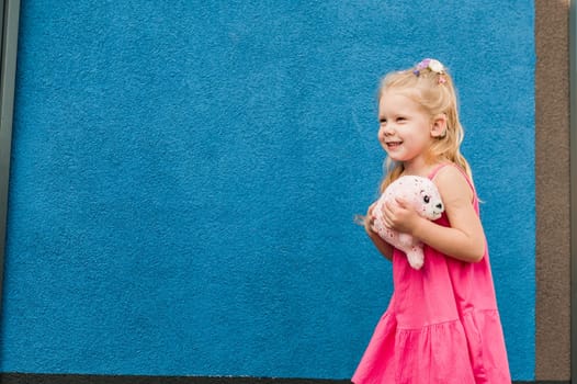 Funny baby with cochlear implant walks outdoor. Hearing aid and medicine innovating technology concept. Diversity and inclusion. Copy space.