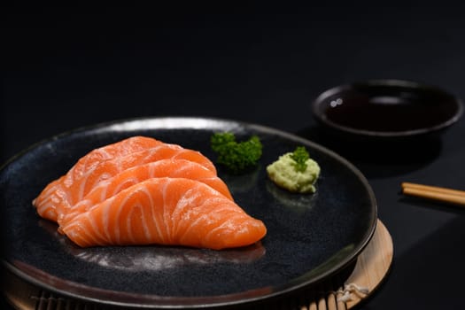 Sliced raw fatty salmon or salmon sashimi serve on with wasabi. Japanese food style concept.