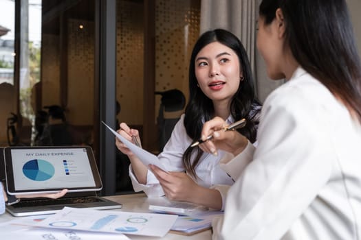 A team of business people brainstorm together about a work plan. Business management and discussing ways to work together in the meeting room.