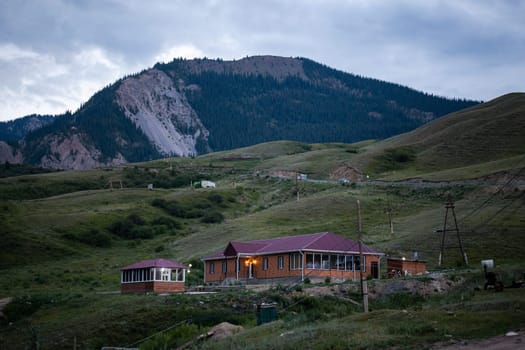 A yurt camp in the Kyrgyz mountains with a beautiful sunset view. Traditional felt yurts used by nomads in summer.