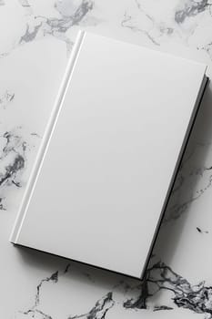 A rectangle white book rests on a sleek marble surface, creating a contrast of shapes and textures. The monochrome photography captures the transparency of the glasslike flooring beneath it