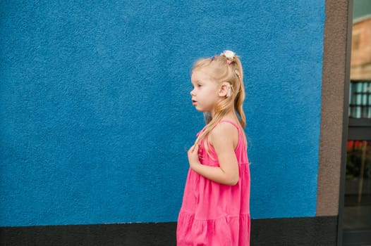 Child girl with hearing aids and cochlear implants having fun outdoor speak and playing. Copy space and empty place for advertising.