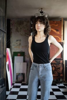 young beautiful woman posing in blue jeans in studio