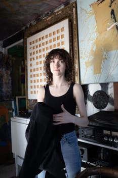 young beautiful woman posing in blue jeans in studio