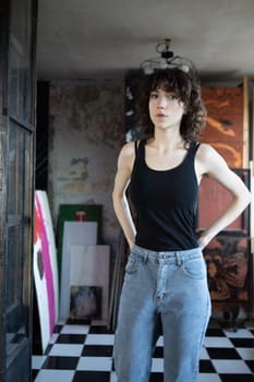 young beautiful woman posing in blue jeans in studio