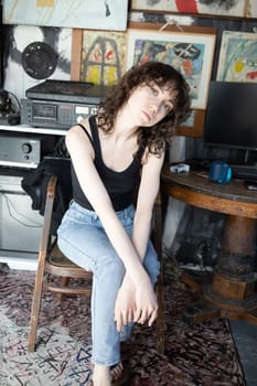 young beautiful woman posing in blue jeans in studio