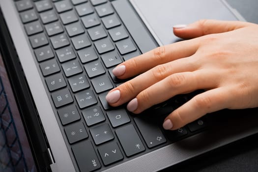 BERLIN, GERMANY - APRIL 14 2024: Female keeps fingers on keyboard for playing games.