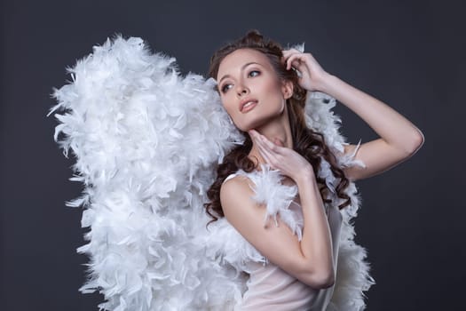 Portrait of beautiful woman in angel costume with wings