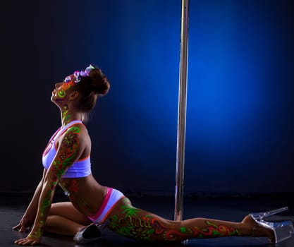 Studio photo of nightclub dancer with luminous bodyart