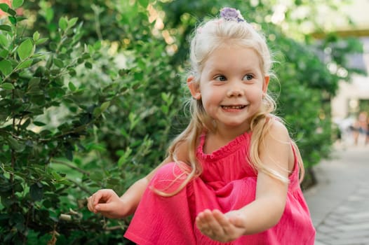 Child girl with hearing aids and cochlear implants having fun outdoor speak and playing. Copy space and empty place for advertising.