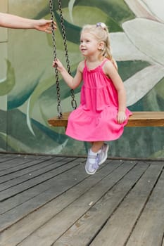 Child with hearing problem and cochlear implant dance in street, deaf kid began to hear. Hearing loss in childhood and treatment concept. Copy space and empty place for text.