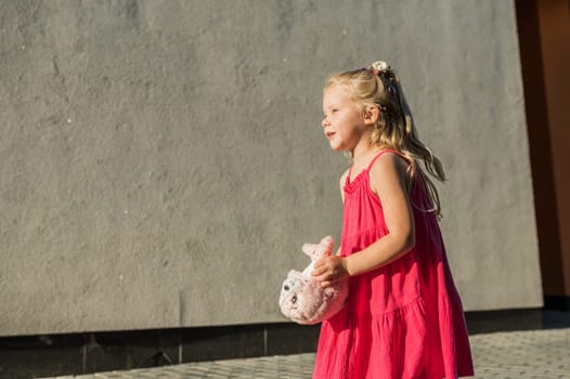 Funny baby with cochlear implant walks outdoor. Hearing aid and medicine innovating technology concept. Diversity and inclusion. Copy space.