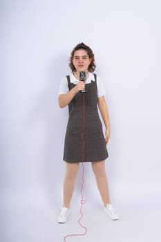 With microphone in a hand positive teenage girl singer, young karaoke singer hold microphone.