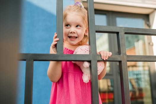 Happy cute child girl having fun outdoor in summer time. Children and generation alpha concept.