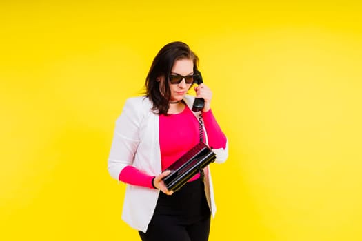Photo of a plump lady talking retro phone empty space isolated yellow color background