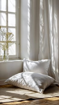 bedroom corner warmly illuminated by soft morning sunlight streaming through a large window, casting a peaceful glow on the plush white pillows resting on the wooden floor - Generative AI
