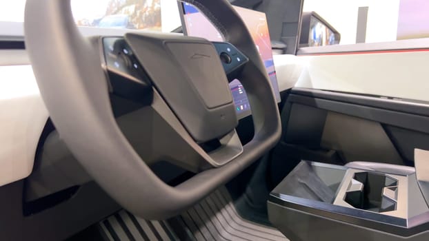 Colorado Springs, Colorado, USA-March 23, 2024-The futuristic Tesla Cybertruck takes center stage in the showroom of a Tesla store, with interested visitors and sleek car designs in the backdrop, all within the Park Meadows Mall.