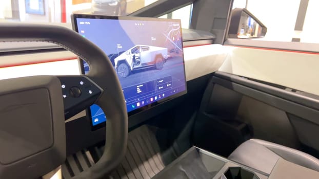 Colorado Springs, Colorado, USA-March 23, 2024-The futuristic Tesla Cybertruck takes center stage in the showroom of a Tesla store, with interested visitors and sleek car designs in the backdrop, all within the Park Meadows Mall.