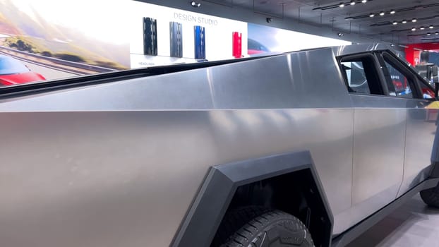 Colorado Springs, Colorado, USA-March 23, 2024-The futuristic Tesla Cybertruck takes center stage in the showroom of a Tesla store, with interested visitors and sleek car designs in the backdrop, all within the Park Meadows Mall.