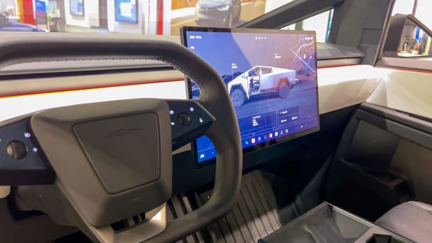 Colorado Springs, Colorado, USA-March 23, 2024-The futuristic Tesla Cybertruck takes center stage in the showroom of a Tesla store, with interested visitors and sleek car designs in the backdrop, all within the Park Meadows Mall.