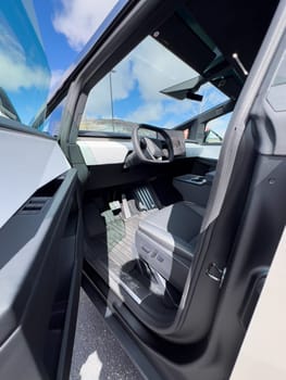 Denver, Colorado, USA-March 28, 2024-The cabin of the Tesla Cybertruck reveals a futuristic and minimalistic design, highlighting a spacious seating arrangement and a prominent, wide touchscreen display on the dashboard.