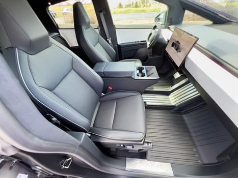 Denver, Colorado, USA-March 28, 2024-The cabin of the Tesla Cybertruck reveals a futuristic and minimalistic design, highlighting a spacious seating arrangement and a prominent, wide touchscreen display on the dashboard.