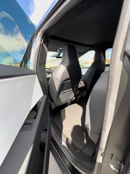 Denver, Colorado, USA-March 28, 2024-The interior shot of the Tesla Cybertruck showcases the roomy rear cabin with its modern, streamlined seats and durable flooring, reflecting the blend of utility and design.