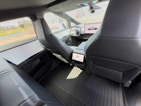 Denver, Colorado, USA-March 28, 2024-The interior shot of the Tesla Cybertruck showcases the roomy rear cabin with its modern, streamlined seats and durable flooring, reflecting the blend of utility and design.